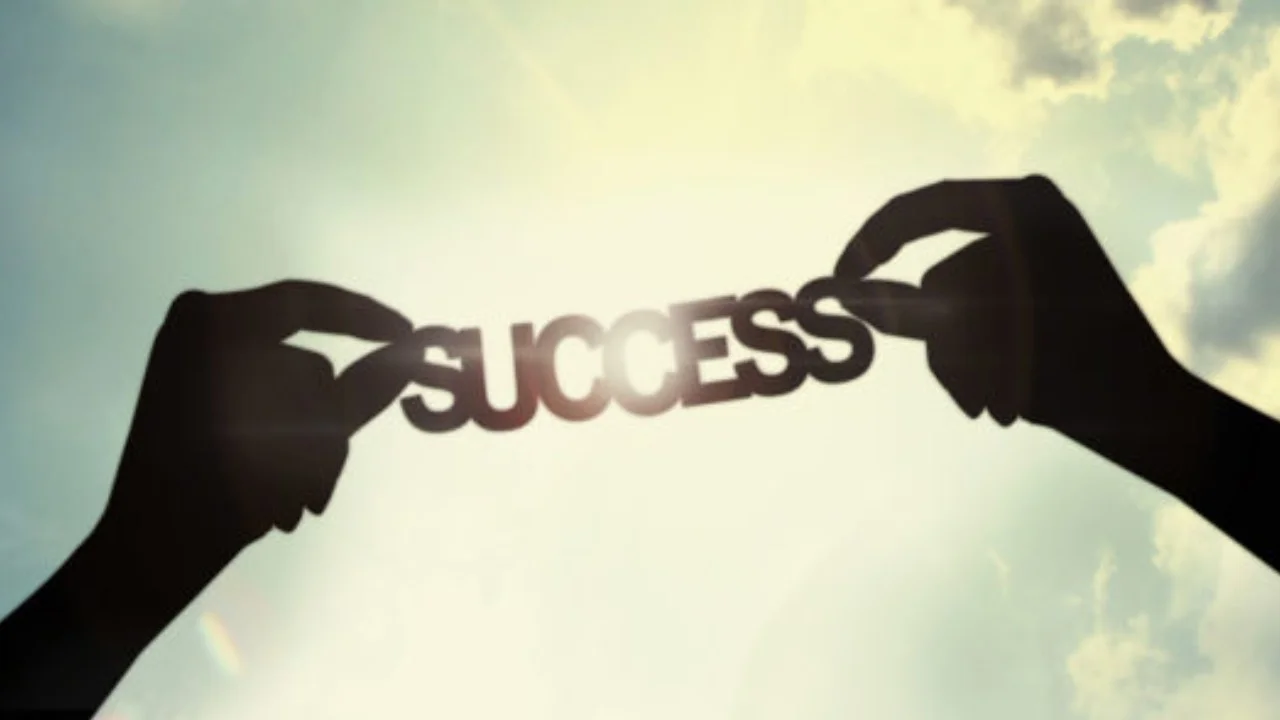 two hands holding success